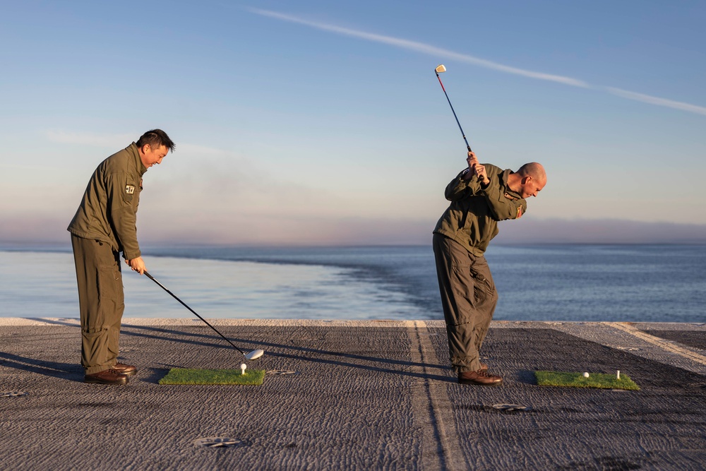 Abraham Lincoln Sailors golf on the flight deck