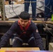USS Ronald Reagan (CVN 76) Sailors move cargo