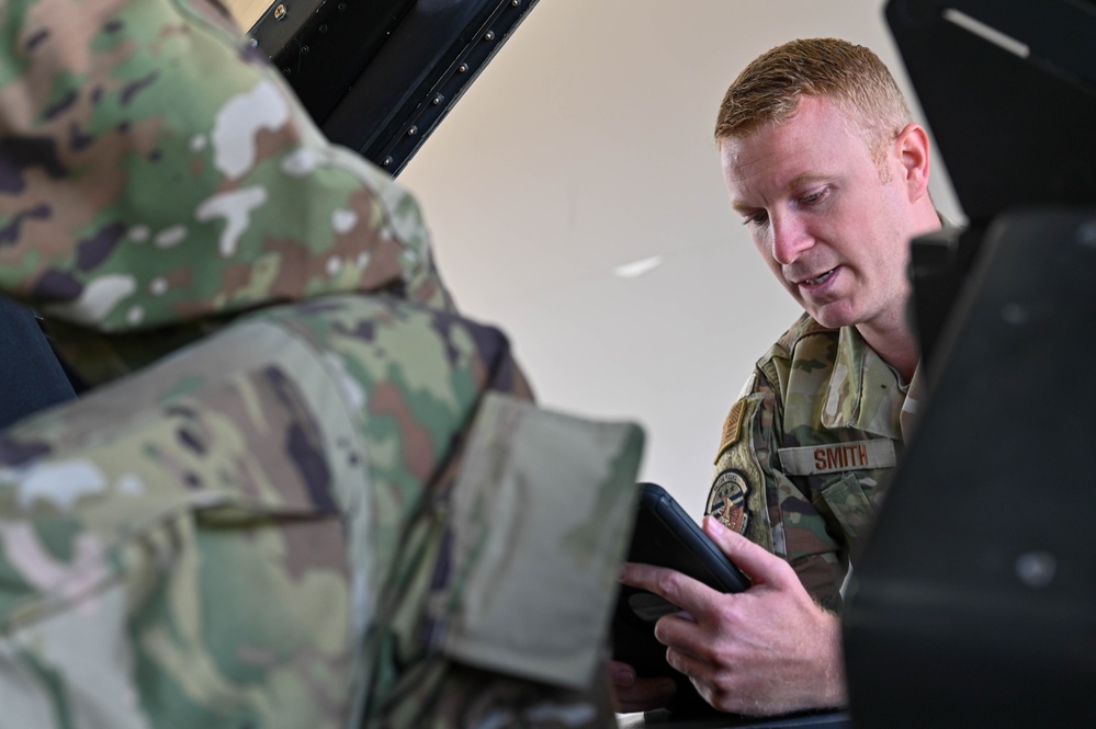 Siblings sharing in service: DC Air National Guard brothers inspect an F-16