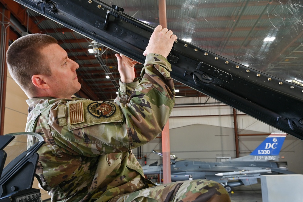 Siblings sharing in service: DC Air National Guard brothers inspect an F-16