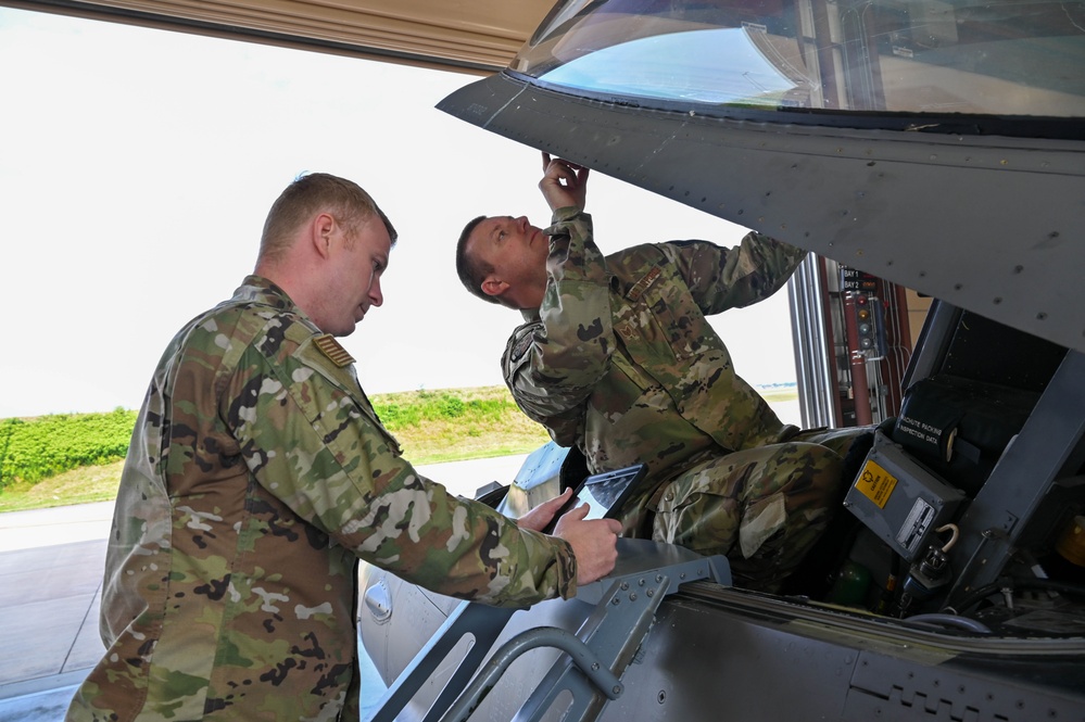 Siblings sharing in service: DC Air National Guard brothers inspect an F-16