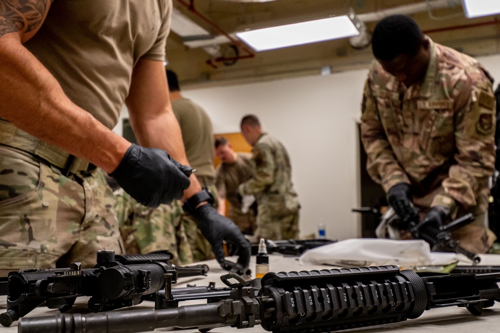 920th Airmen clean weapons