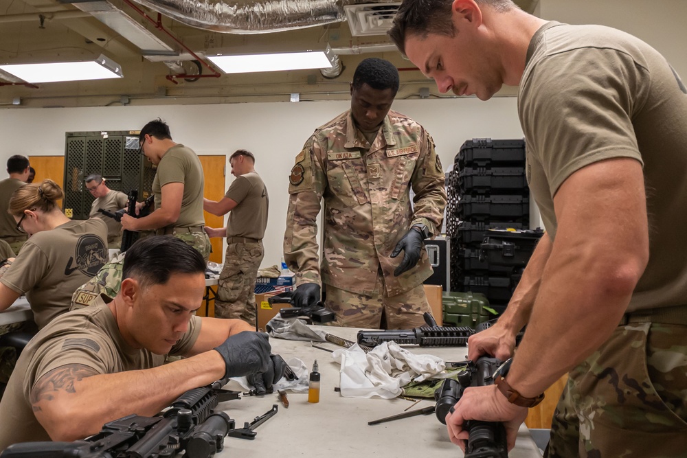 920th Airmen clean weapons