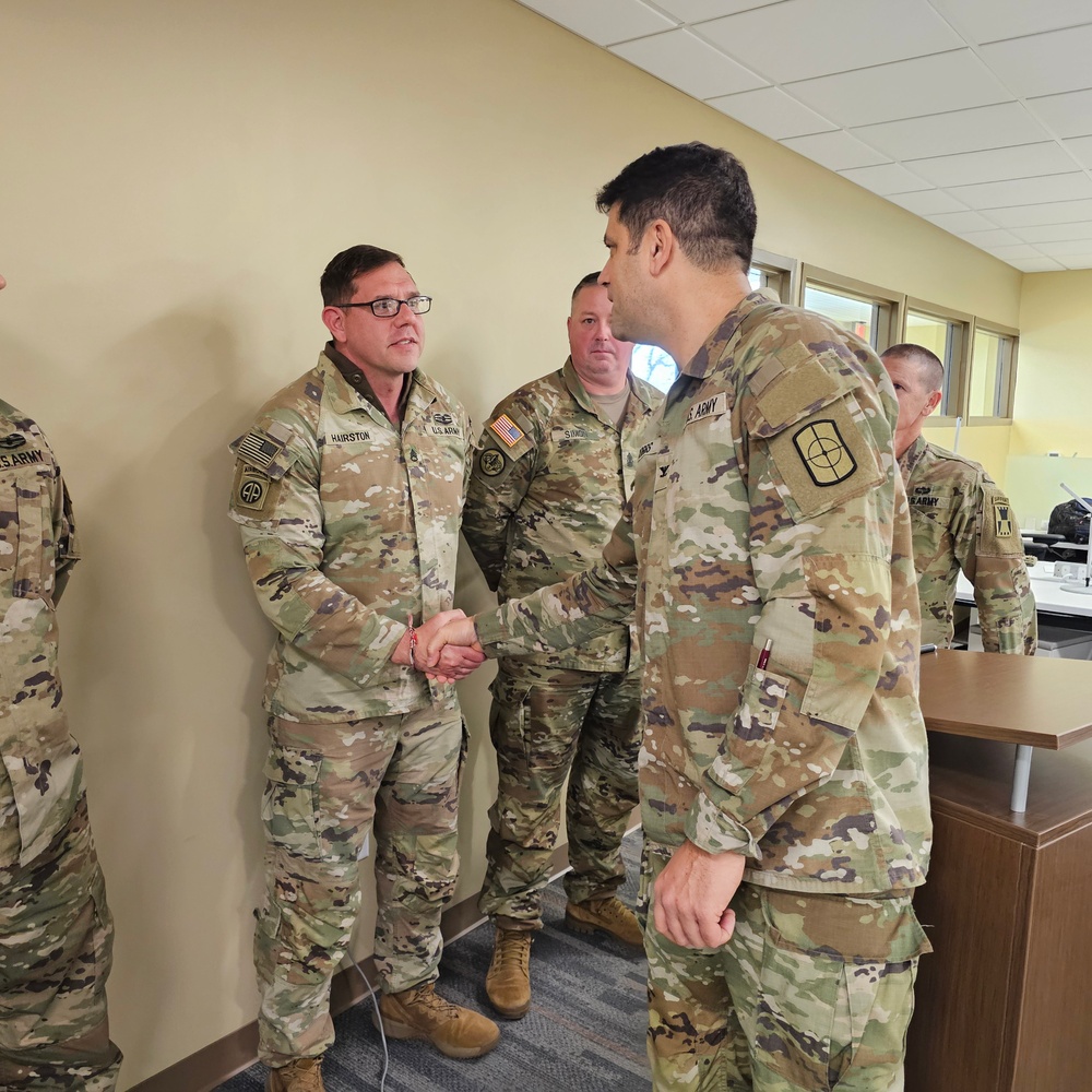 Staff Sgt. Michael Hairston receives a Commander's Coin of Excellence