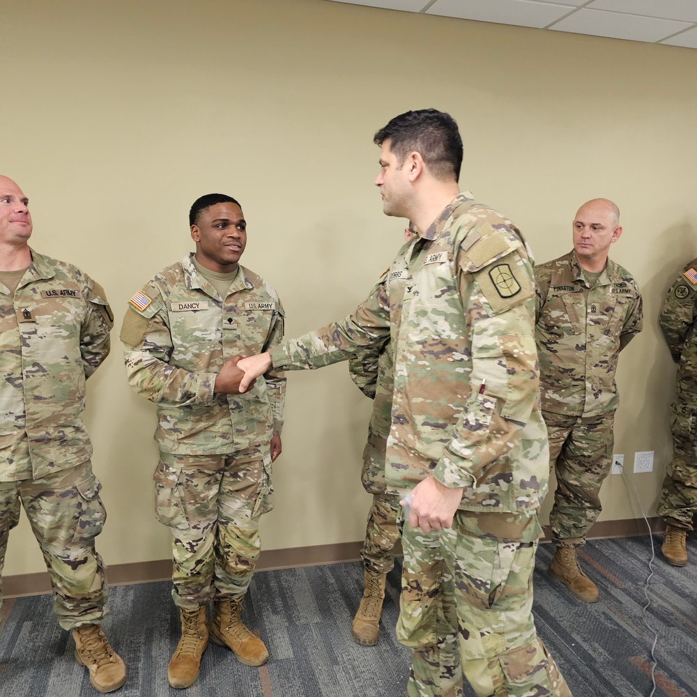 Spc. Austin Dancy receives a Commander's Coin of Excellence