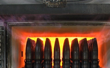 Projectiles cartridge cases being heat treated
