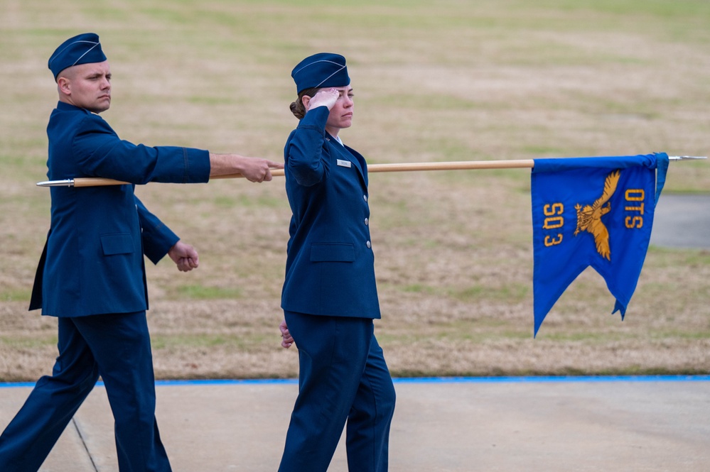 Newly commissioned Air Force lieutenants march by for pass and review