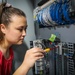 NSWC IHD engineer performs field wiring on a shipboard programmable logic controller