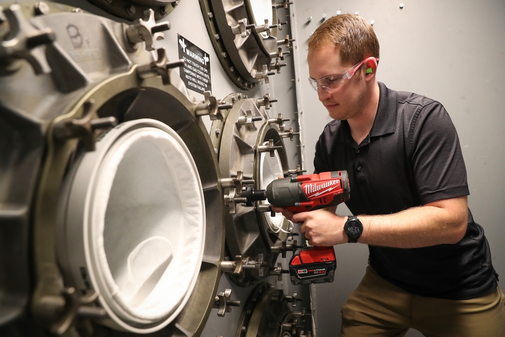 NSWC IHD engineer performs filter maintenance on the CBR filtration system