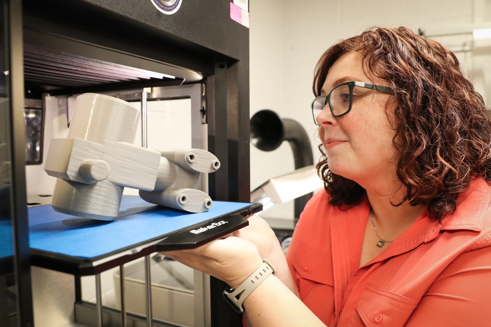 NSWC IHD CBRD engineer removes a completed model from a 3-D printer
