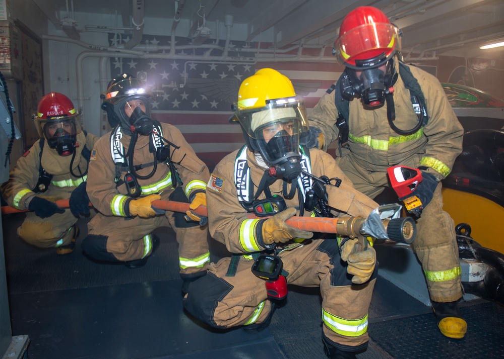 USS Ronald Reagan (CVN 76) conducts a joint damage control drill