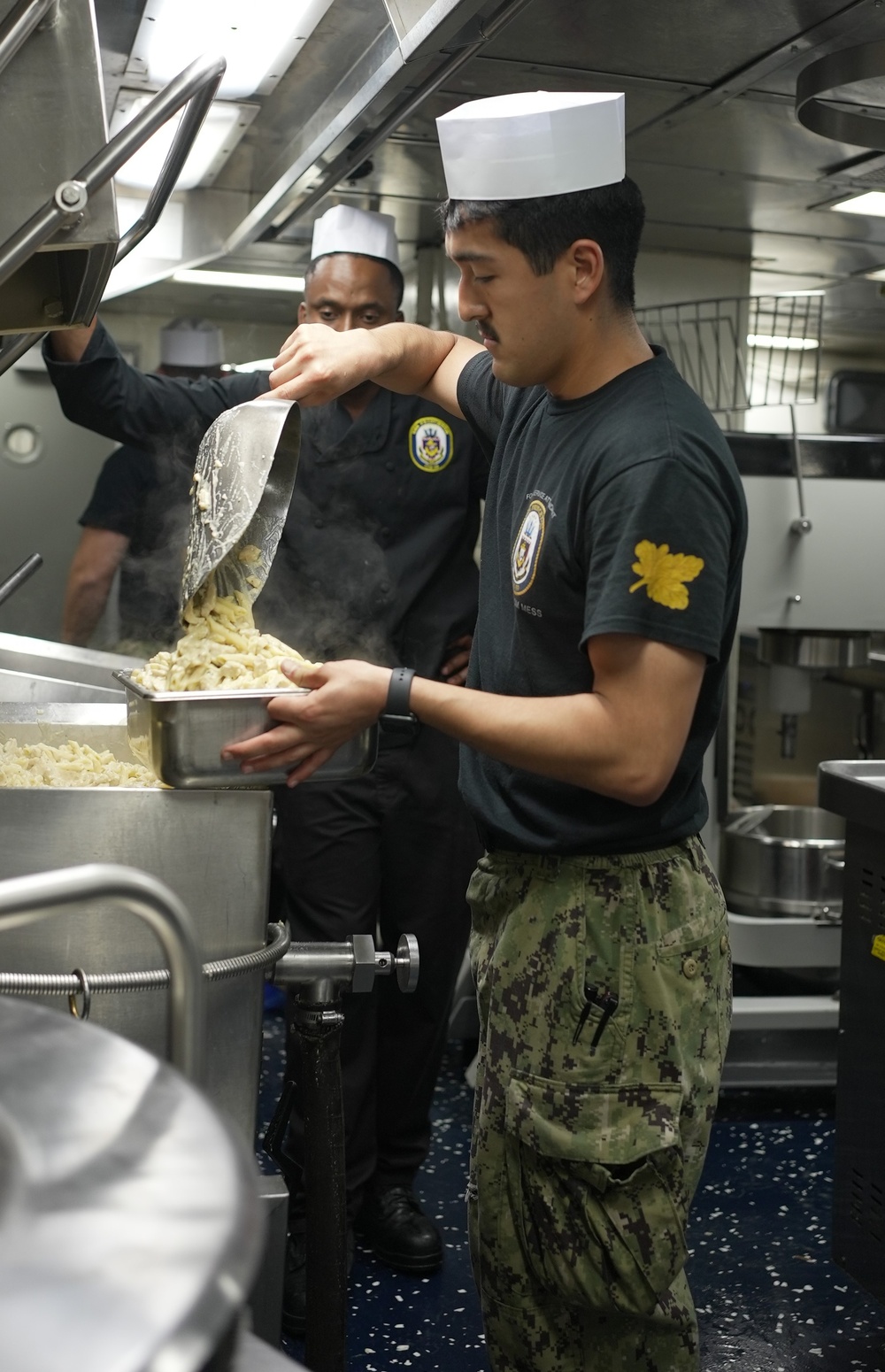 Sailor Prepares Food in the Galley