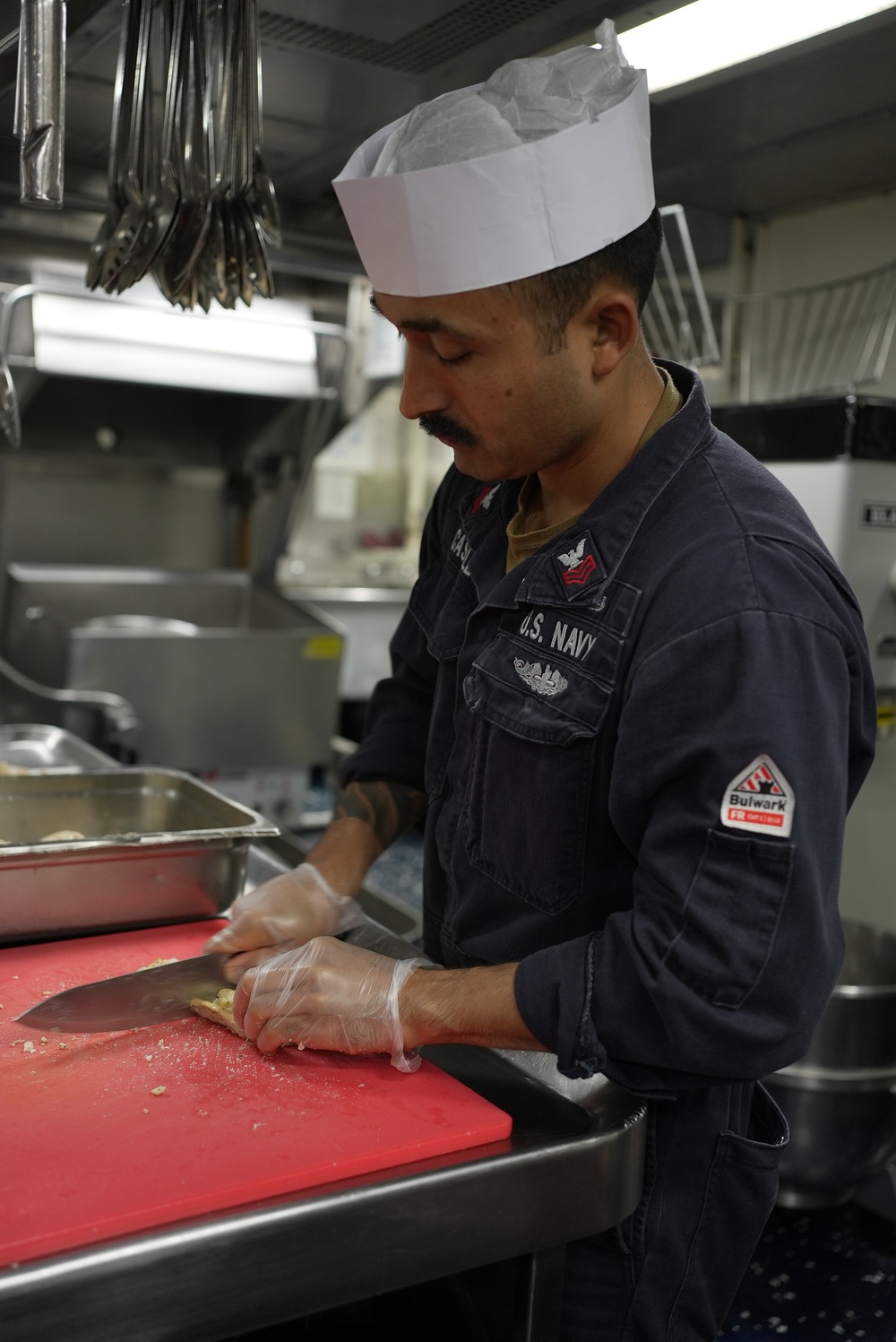 Sailor Prepares Food in the Galley