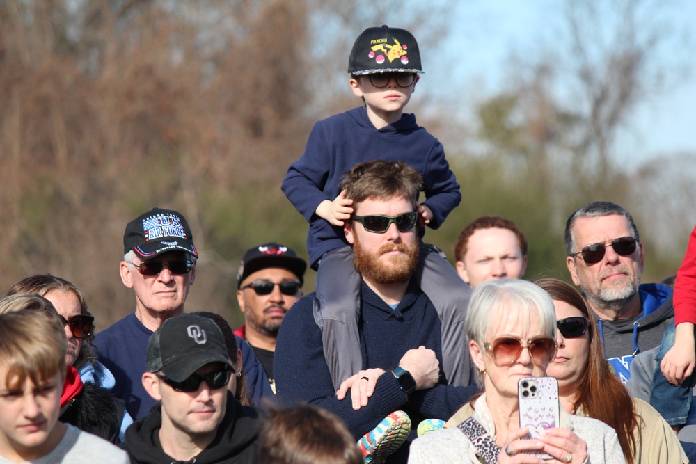 Children watch on parents shoulders during Wreaths Across America event at Yorktown National Cemetery