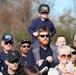 Children watch on parents shoulders during Wreaths Across America event at Yorktown National Cemetery