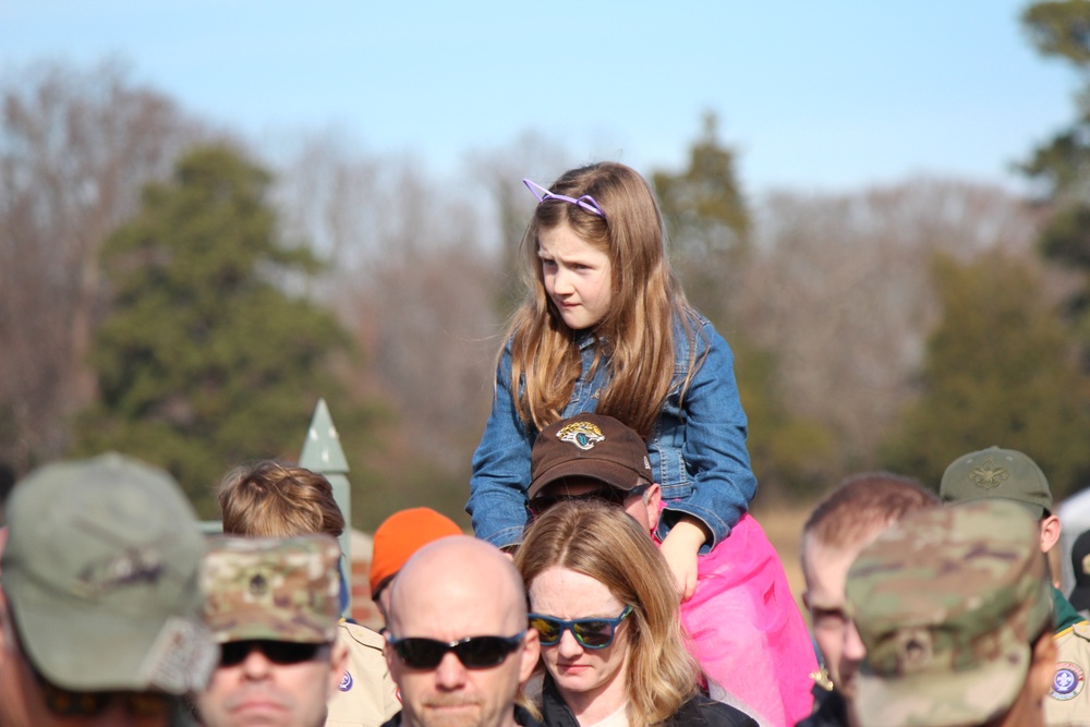 Children watch on parents shoulders during Wreaths Across America event at Yorktown National Cemetery