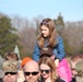 Children watch on parents shoulders during Wreaths Across America event at Yorktown National Cemetery