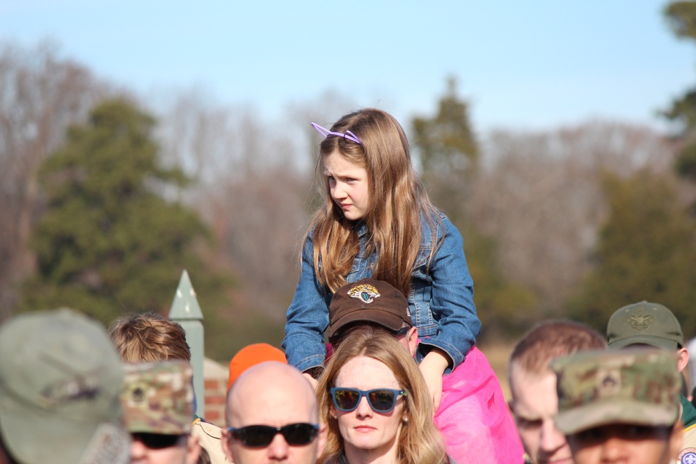 Children watch on parents shoulders during Wreaths Across America event at Yorktown National Cemetery