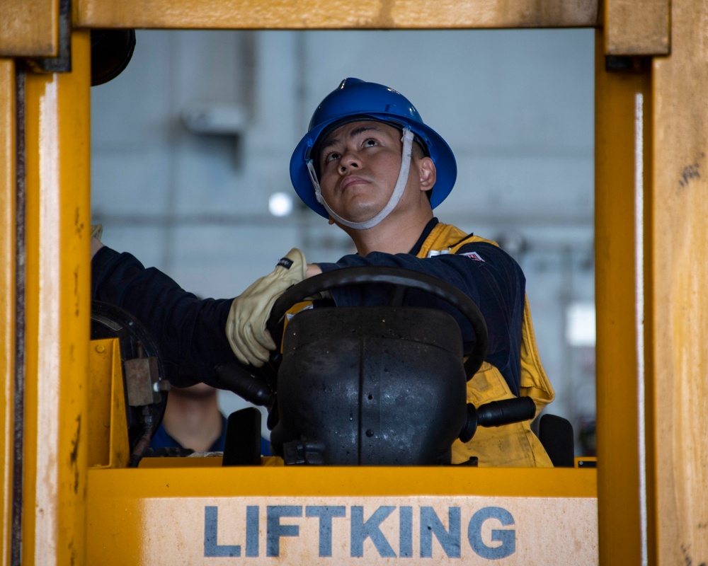 Sailor Operates A Forklift Aboard USS Carl Vinson (CVN 70)