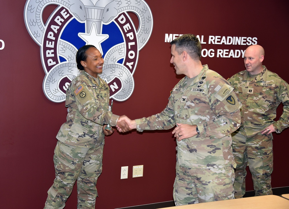 COL Welde congratulates SSG Kemp