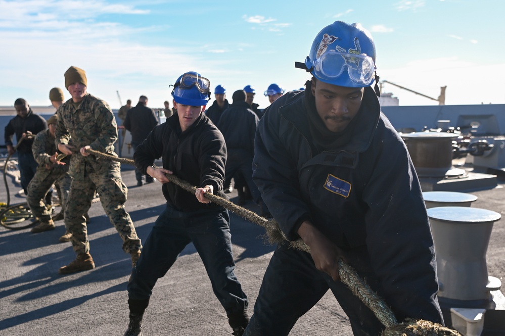 U.S Sailors and Marines handle line aboard USS New York (LPD-21)