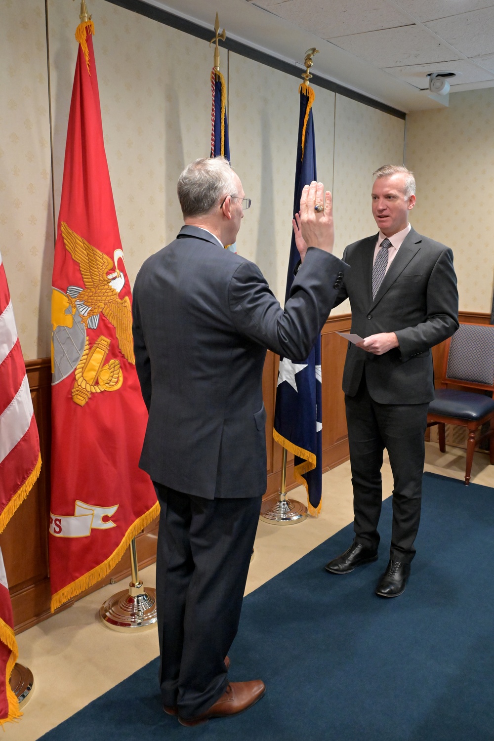 Assistant Secretary of the Navy for Research, Development, and Acquisition Nickolas H. Guertin takes an oath as he is sworn in by the Under Secretary of the Navy Erik Raven