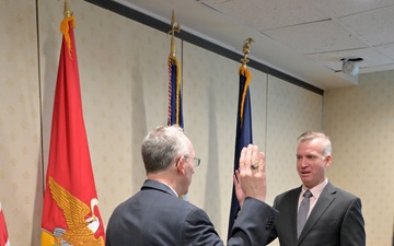 Assistant Secretary of the Navy for Research, Development, and Acquisition Nickolas H. Guertin takes an oath as he is sworn in by the Under Secretary of the Navy Erik Raven