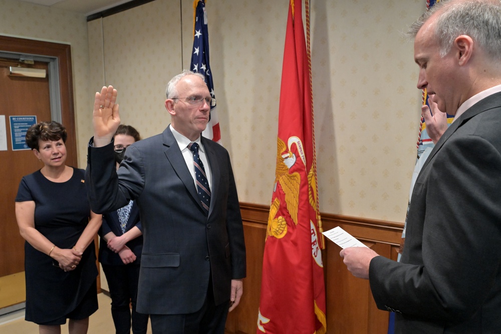 Assistant Secretary of the Navy for Research, Development, and Acquisition Nickolas H. Guertin takes an oath as he is sworn in by the Under Secretary of the Navy Erik Raven