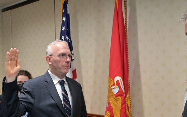 Assistant Secretary of the Navy for Research, Development, and Acquisition Nickolas H. Guertin takes an oath as he is sworn in by the Under Secretary of the Navy Erik Raven