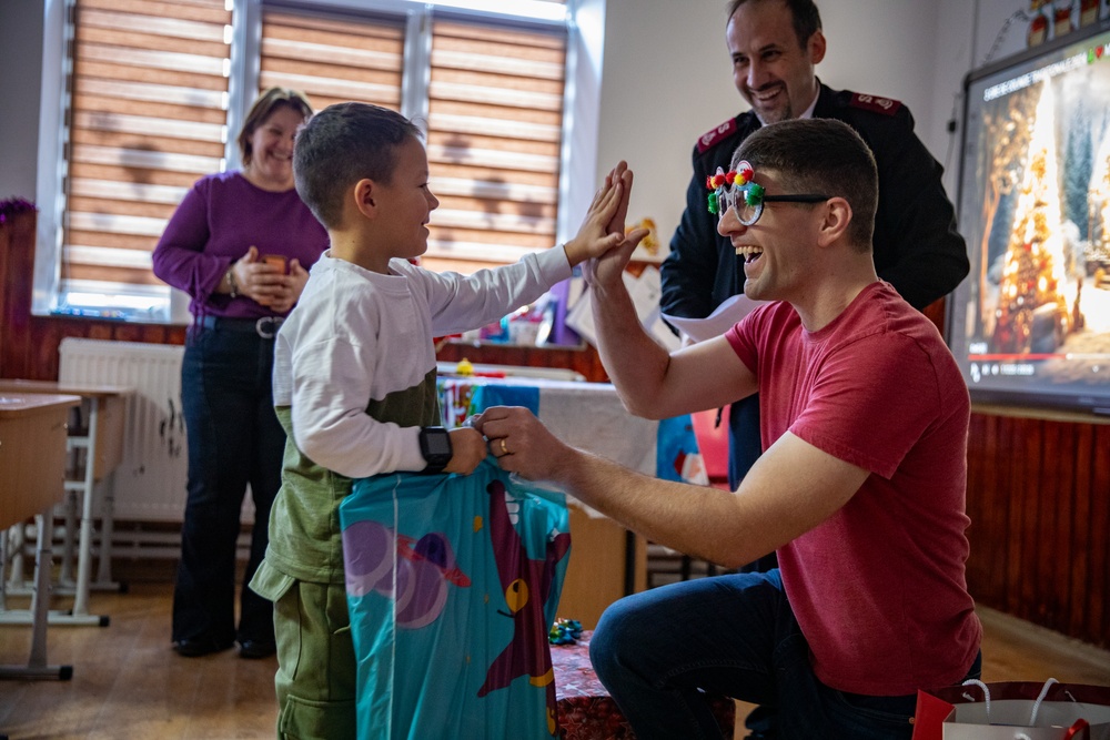 Paratroopers from Task Force 82 present gifts to children during Operation Angel Tree