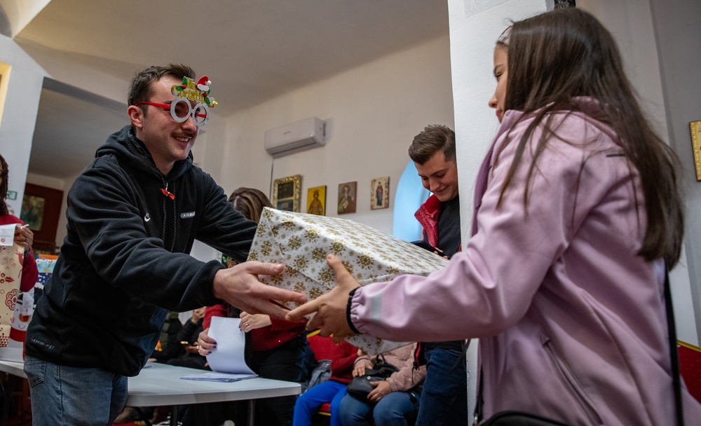 Paratroopers from Task Force 82 present gifts to children during Operation Angel Tree