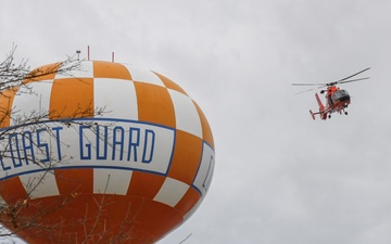 Coast Guard helicopter maneuvers around water tower