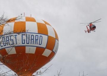Coast Guard helicopter maneuvers around water tower