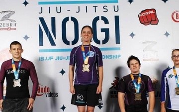 Master Sgt. Megan Lomonof stands on the top podium during one of her 12 International Brazilian Jiu Jitsu Federation gold medal wins. (Courtesy photo)