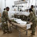 Many hands make light work: Deployed Airmen train to assist mortuary specialists with a full body wrap