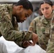 Many hands make light work: Deployed Airmen train to assist mortuary specialists with a full body wrap