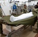 Many hands make light work: Deployed Airmen train to assist mortuary specialists with a full body wrap