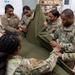 Many hands make light work: Deployed Airmen train to assist mortuary specialists with a full body wrap