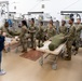 Many hands make light work: Deployed Airmen train to assist mortuary specialists with a full body wrap