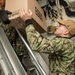 USS Ronald Reagan (CVN 76) Sailors move produce into storage