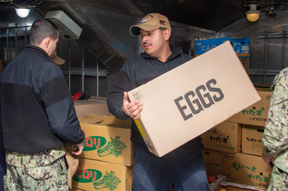 USS Ronald Reagan (CVN 76) Sailors move produce into storage