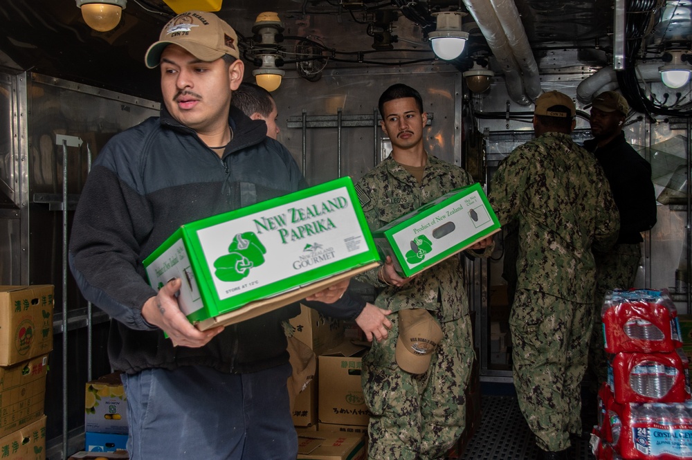 USS Ronald Reagan (CVN 76) Sailors move produce into storage