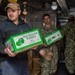 USS Ronald Reagan (CVN 76) Sailors move produce into storage
