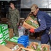 USS Ronald Reagan (CVN 76) Sailors move produce into storage