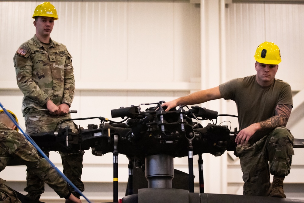 National Guard Helicopter Crew Chiefs conduct Maitenance on Black Hawk Helicopters