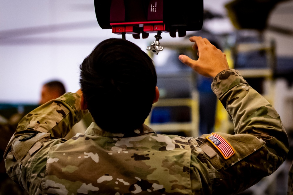 National Guard Helicopter Crew Chiefs conduct Maintenance on Black Hawk Helicopters