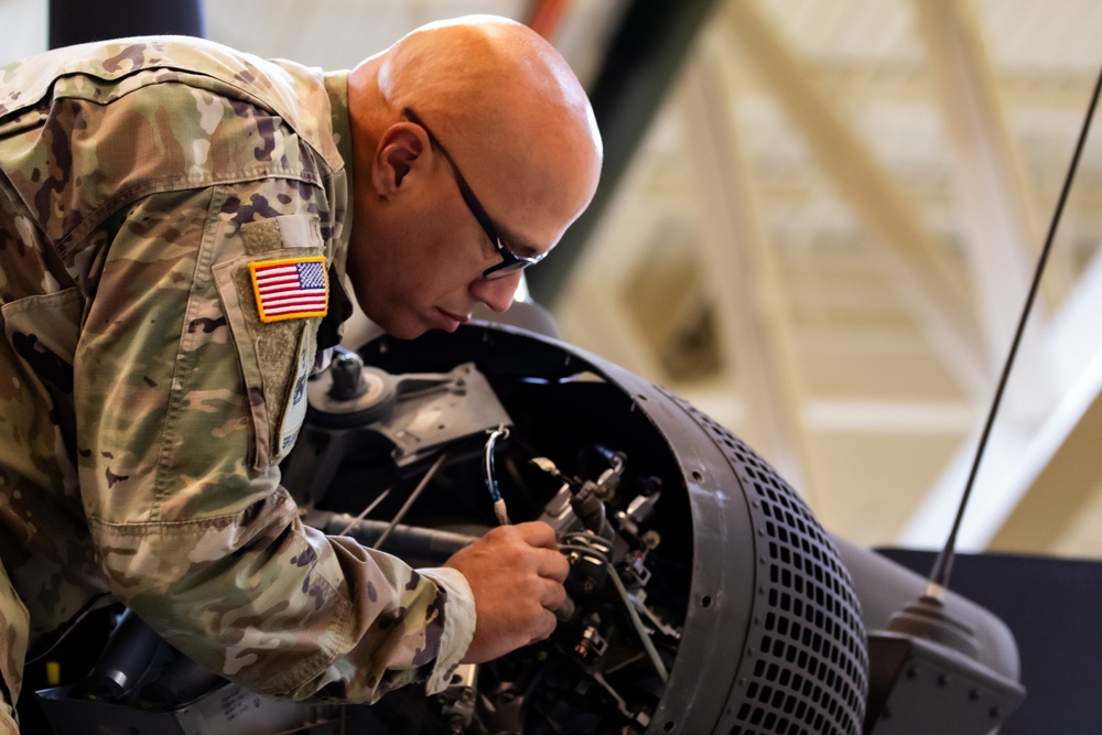 National Guard Helicopter Crew Chiefs conduct Maintenance on Black Hawk Helicopters