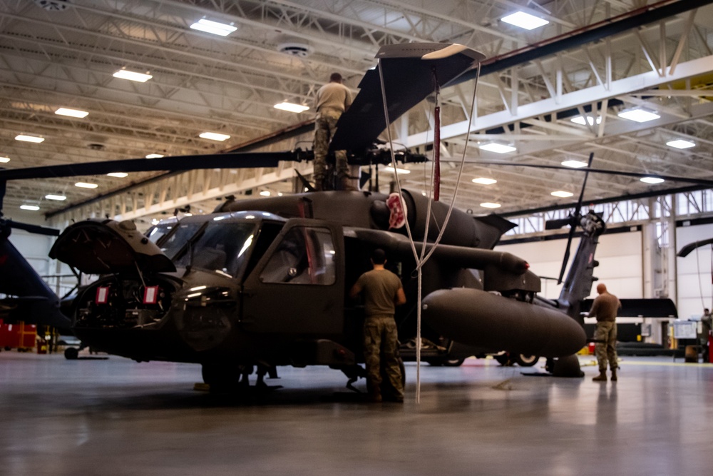 National Guard Helicopter Crew Chiefs conduct Maintenance on Black Hawk Helicopters