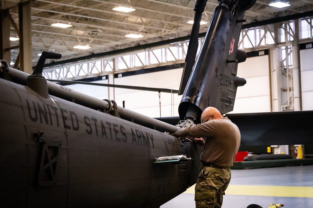 National Guard Helicopter Crew Chiefs conduct Maintenance on Black Hawk Helicopters