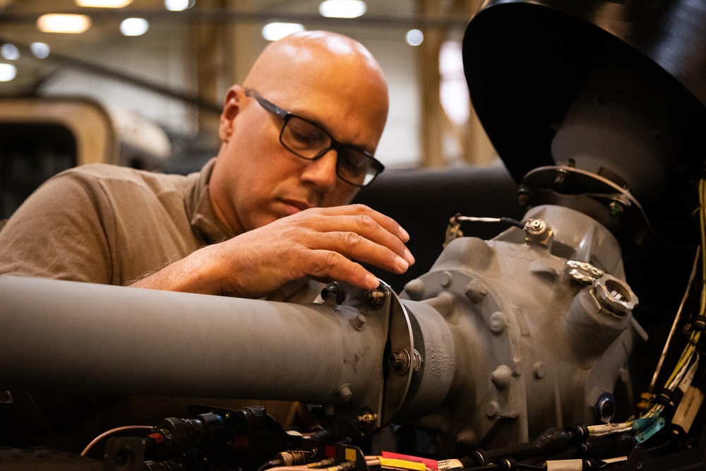 National Guard Helicopter Crew Chiefs conduct Maintenance on Black Hawk Helicopters